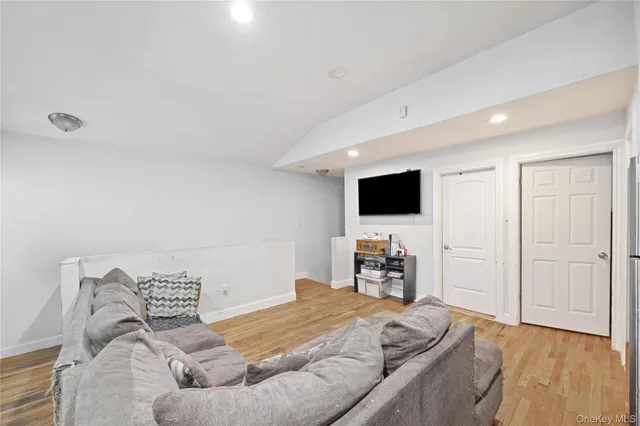 a bedroom with a bed and flat screen tv