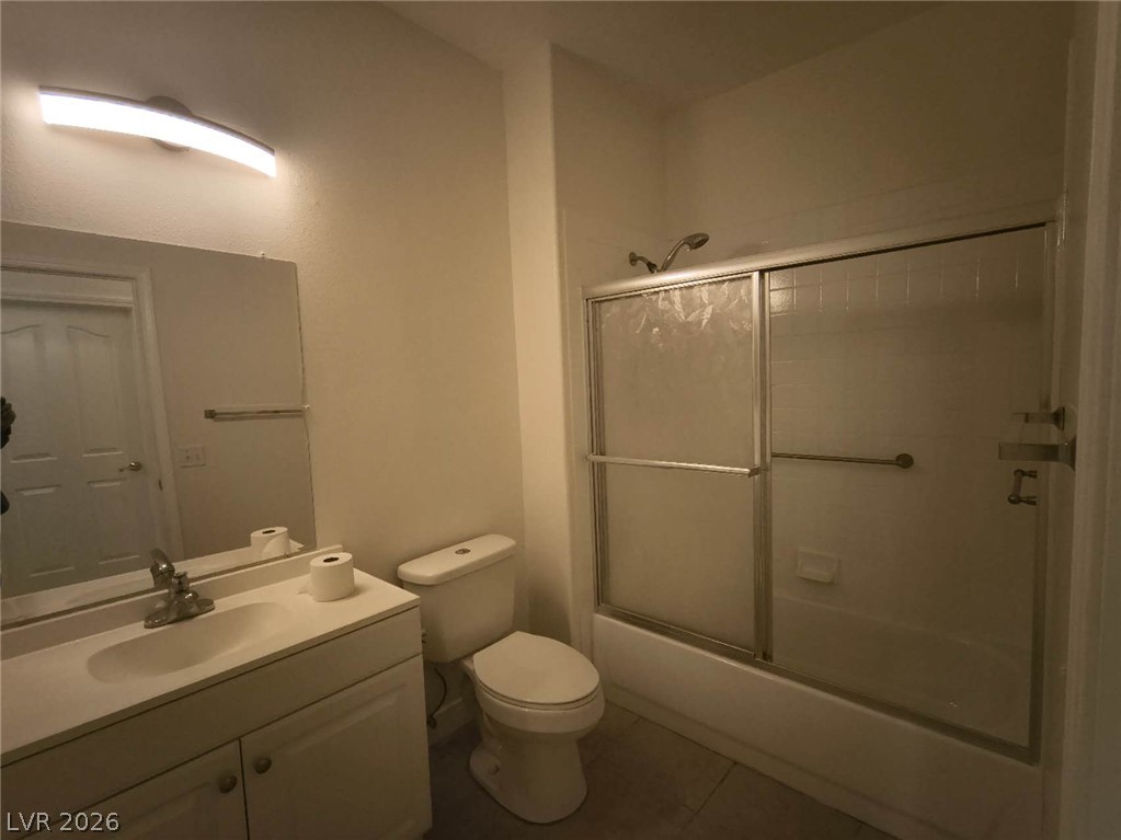 9725 Pima Point Avenue Las Vegas, NV 89147 - Photo 31 of 35 A well-appointed bathroom with a vanity, toilet, and a combined tub and shower.