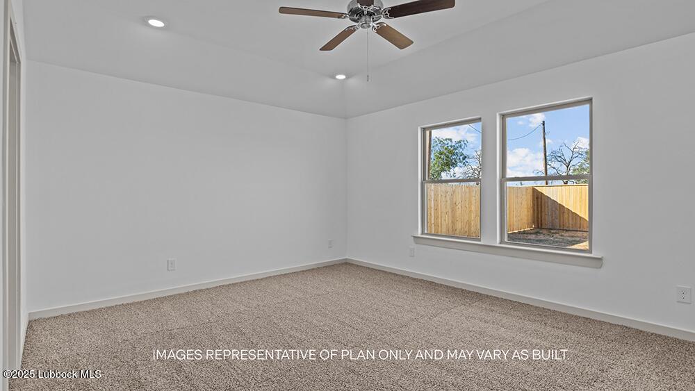 7429 9th Street Lubbock, TX 79416 - Photo 11 of 16 an empty room with windows and fan