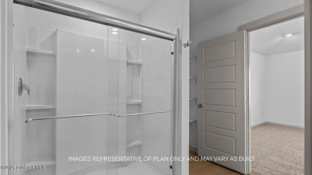 a bathroom with a glass shower door