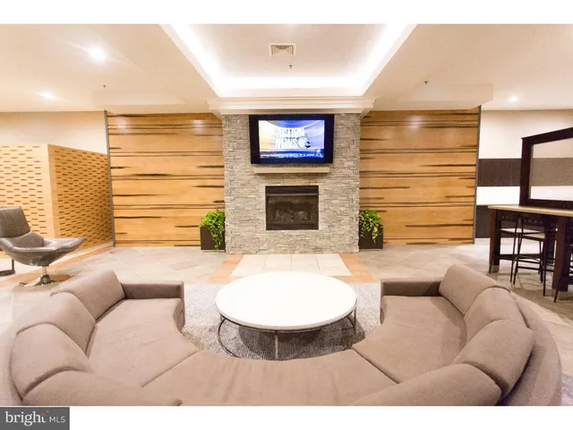 a living room with furniture a large window and a fireplace
