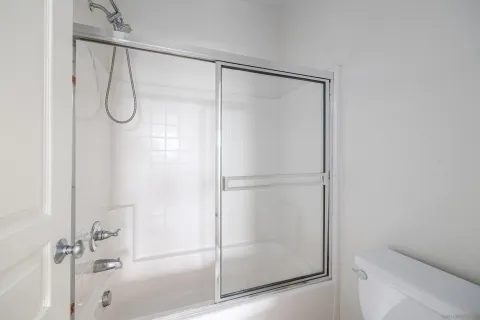a bathroom with a glass shower door