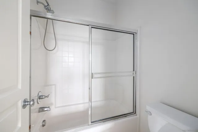 a bathroom with a glass shower door