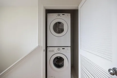a view of a hallway with washer and dryer