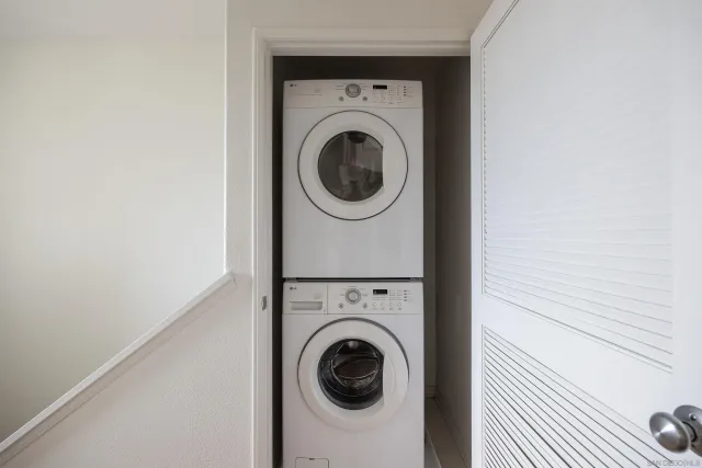 a view of a hallway with washer and dryer