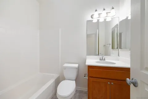 a bathroom with a toilet a sink and a mirror