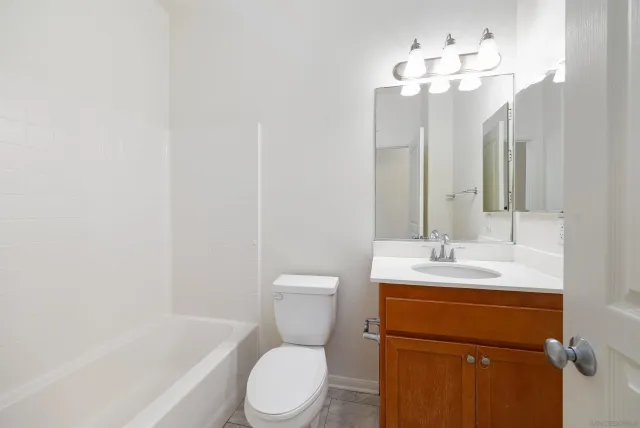 a bathroom with a toilet a sink and a mirror