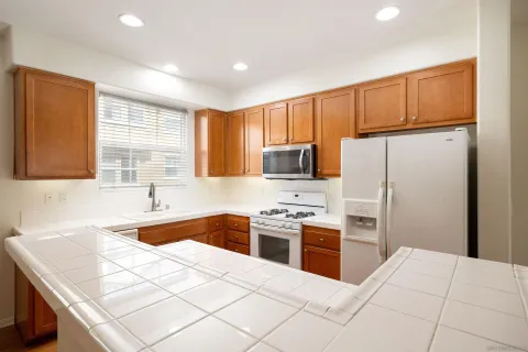 a kitchen with stainless steel appliances a refrigerator sink stove microwave and cabinets