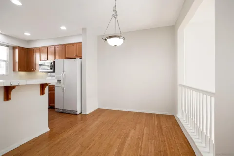 a view of a kitchen with a refrigerator cabinets and wooden floor