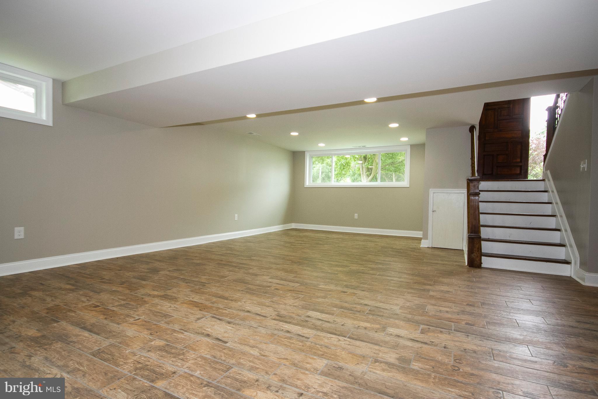 7412 Prince George Road Baltimore, MD 21208 - Photo 13 of 22 an empty room with wooden floor and windows