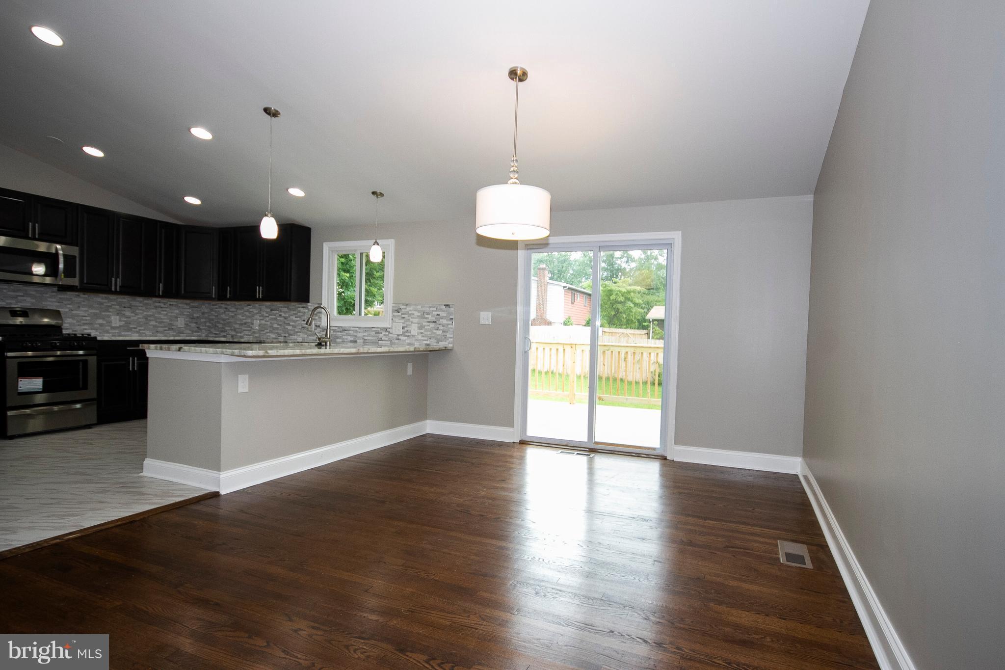 7412 Prince George Road Baltimore, MD 21208 - Photo 4 of 22 a kitchen view with wooden floor and window