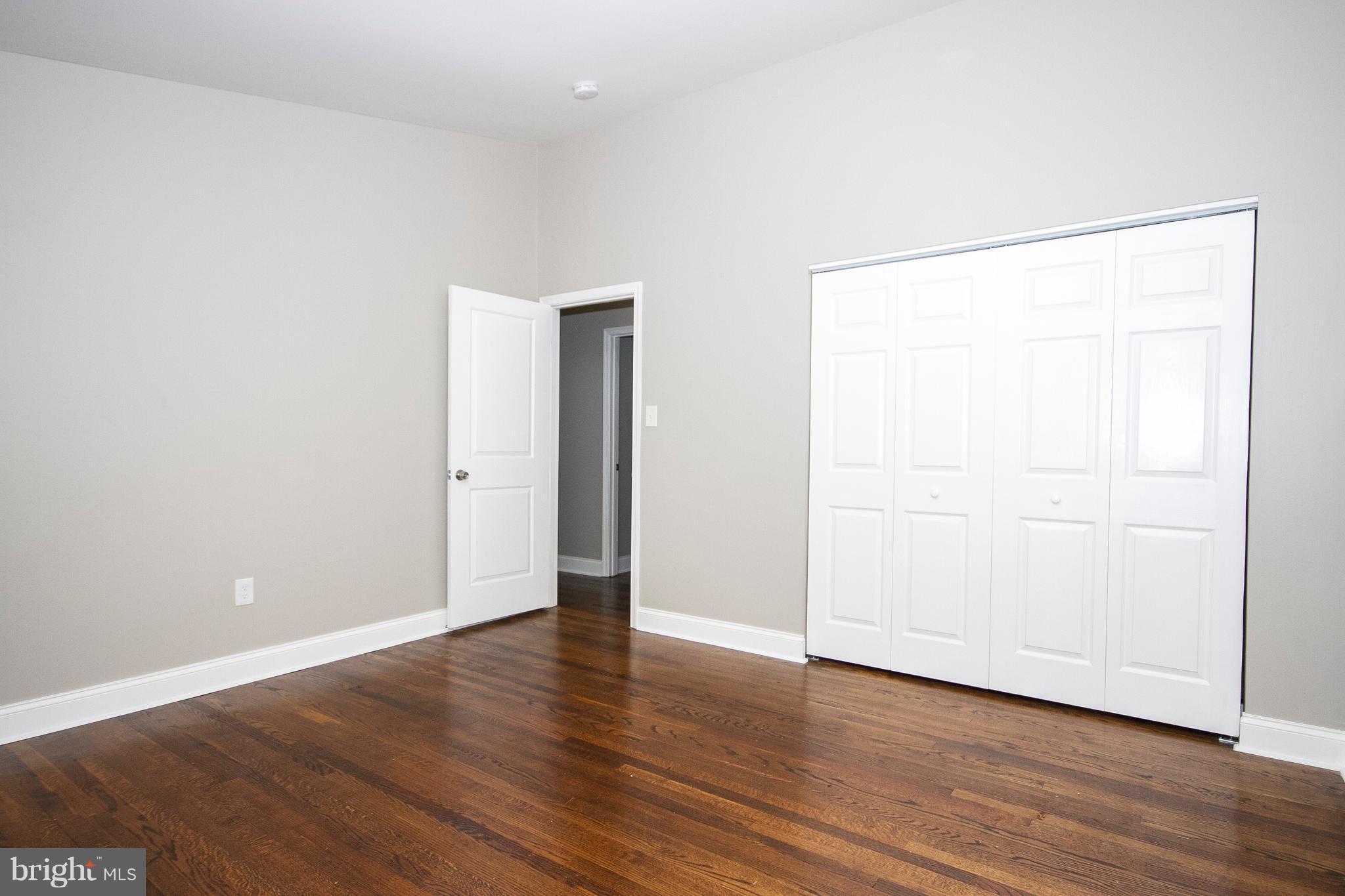 7412 Prince George Road Baltimore, MD 21208 - Photo 8 of 22 an empty room with wooden floor