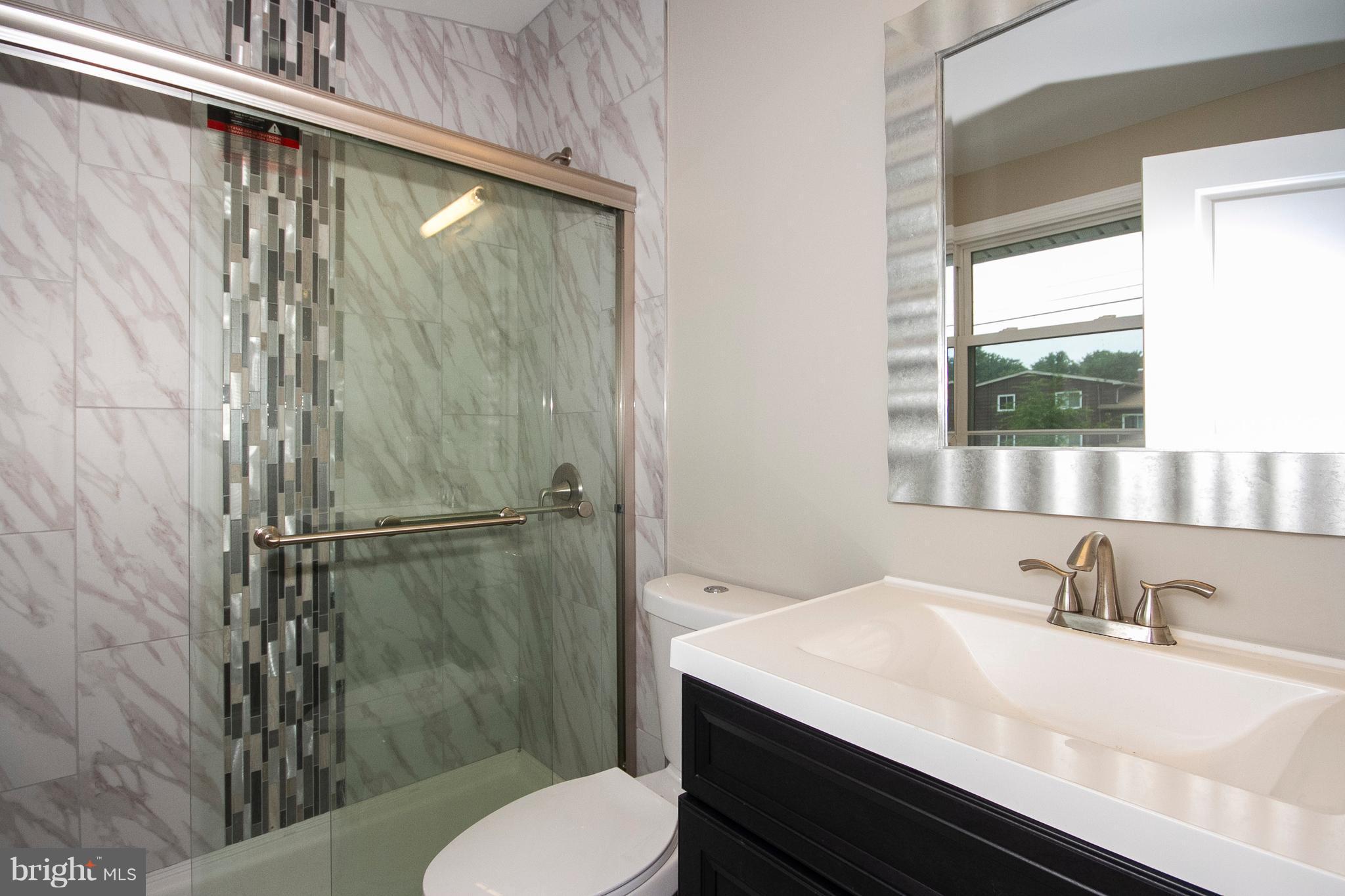 7412 Prince George Road Baltimore, MD 21208 - Photo 9 of 22 a bathroom with a sink toilet and shower