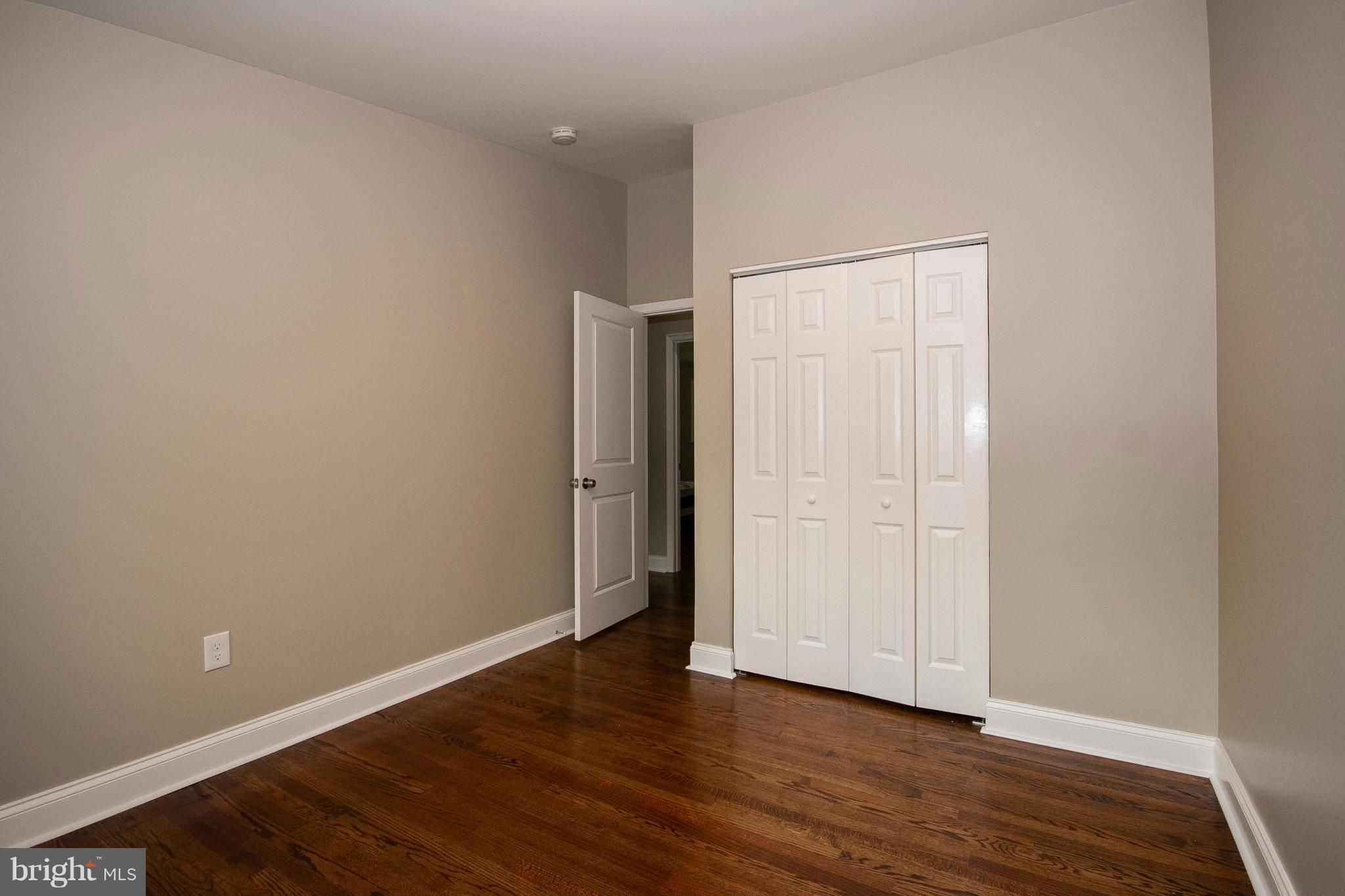7412 Prince George Road Baltimore, MD 21208 - Photo 10 of 22 a view of an empty room with wooden floor