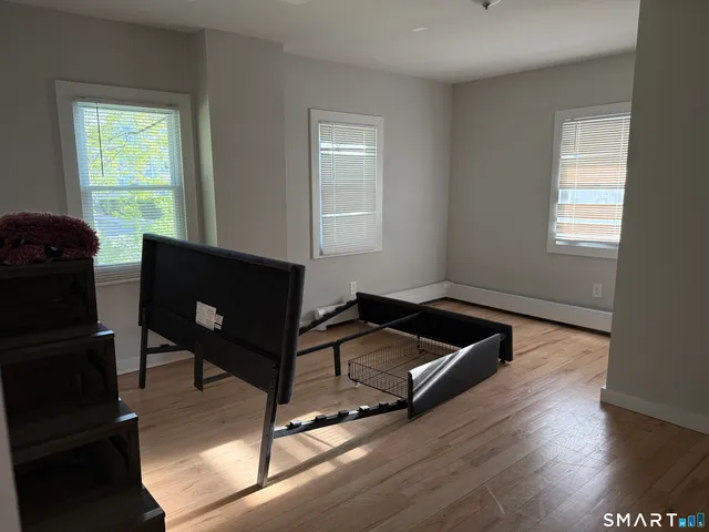 a living room with hard wood floors and a window