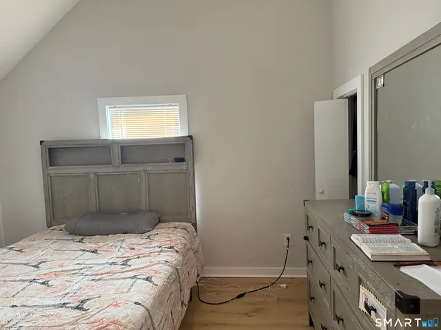 a bedroom with a bed and a window