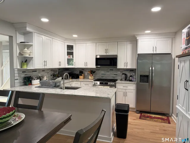 a kitchen with a sink stainless steel appliances and refrigerator