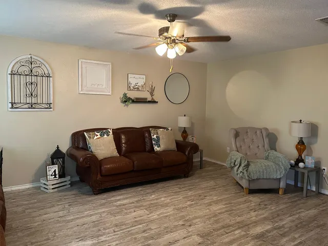 a living room with furniture and a mirror