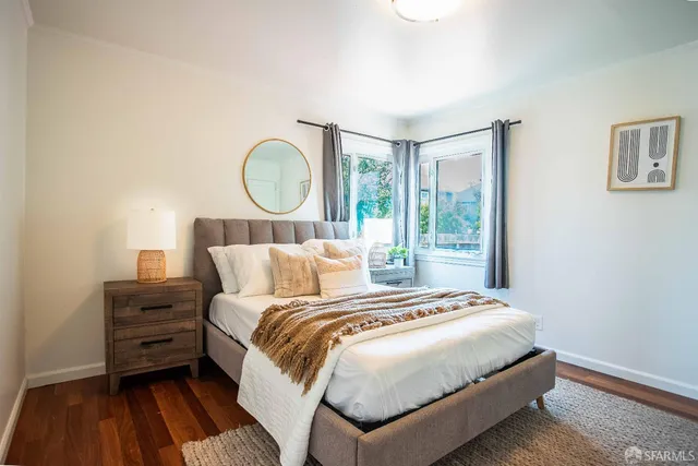 a bedroom with a bed and a large window