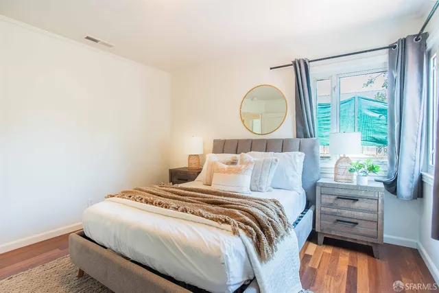 a dining room with furniture and wooden floor