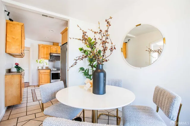 a view of a workspace with furniture and a potted plant