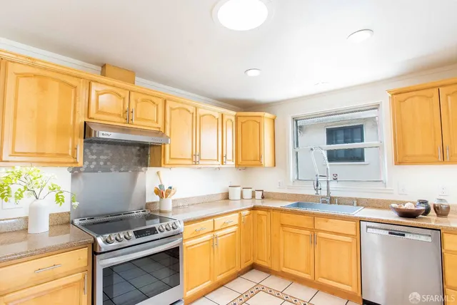a kitchen with a sink appliances and cabinets