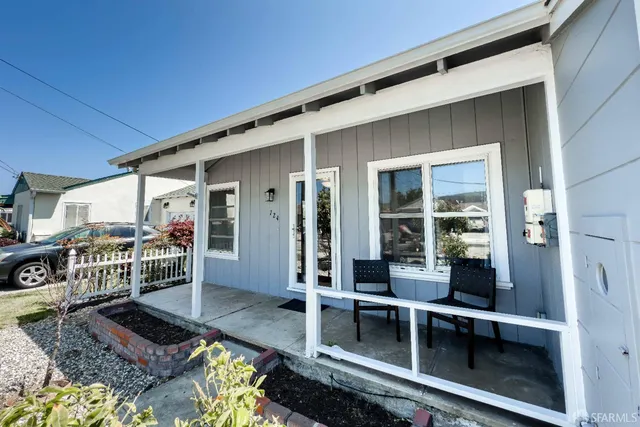 a balcony with table and chairs