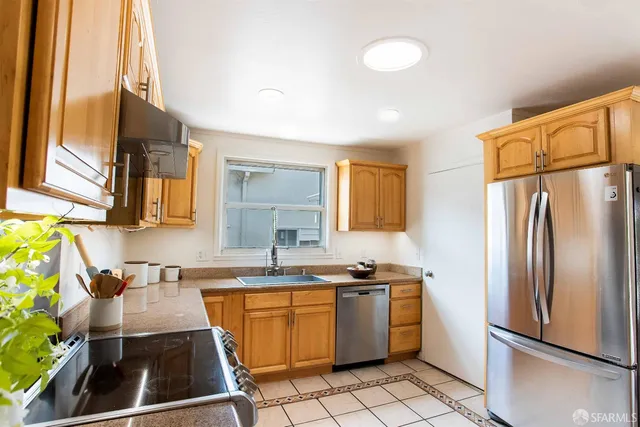 a bathroom with a granite countertop sink a toilet and shower