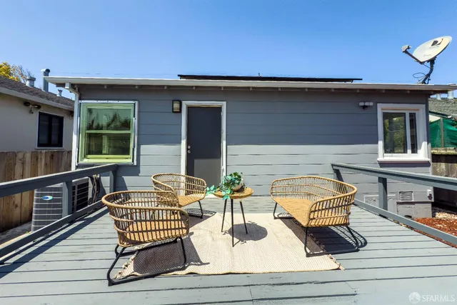 a balcony with wooden floor and furniture