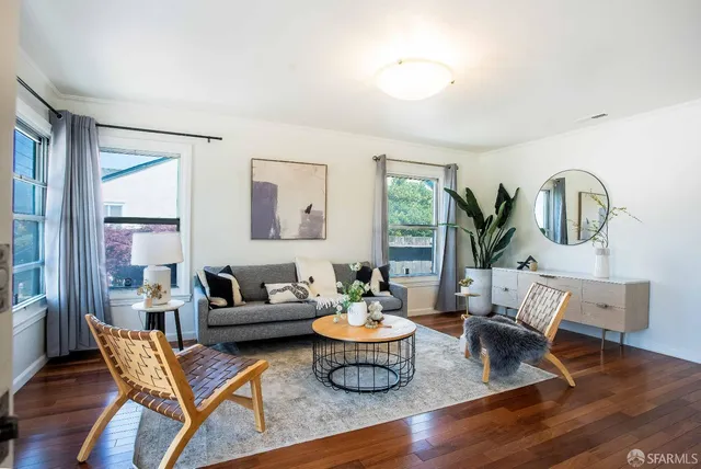 a living room with furniture and wooden floor