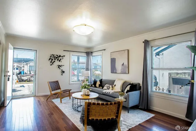 a living room with furniture potted plant and a mirror