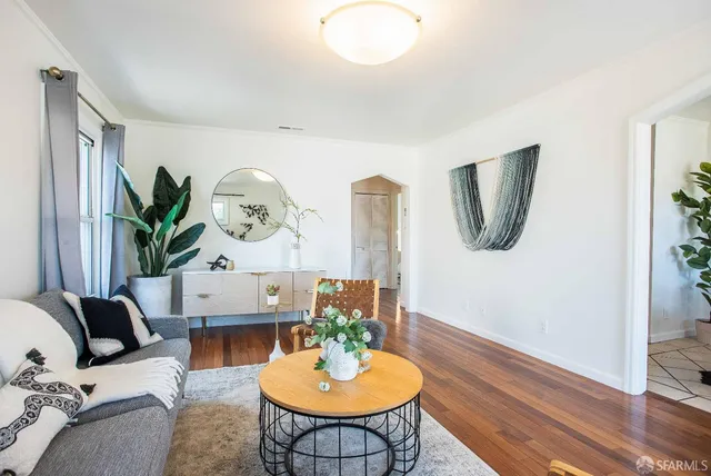 a living room with furniture and a mirror