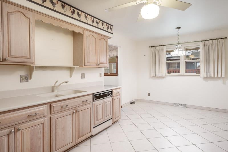 1110 Roxbury Close Rockford, IL 61107 - Photo 10 of 36 a kitchen with a sink cabinets and window