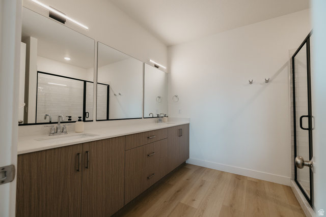 2759 Becco Trail, Unit 16 St. George, UT 84770 - Photo 17 of 42 Bathroom with double vanity, a shower stall, and light wood finished floors