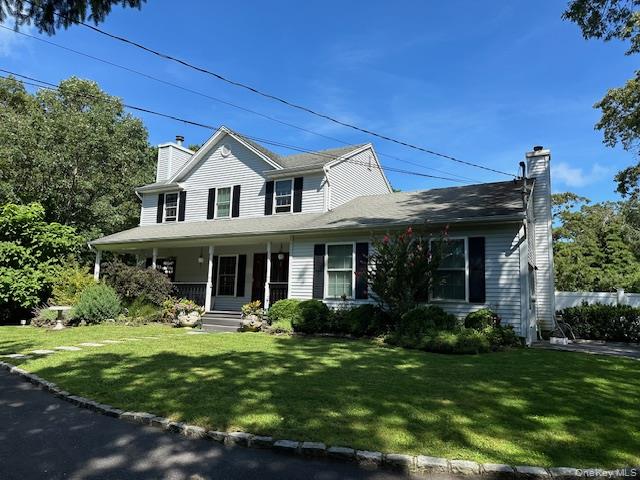 63 East Tiana Road Hampton Bays, NY 11946 - Photo 1 of 30 a front view of a house with garden