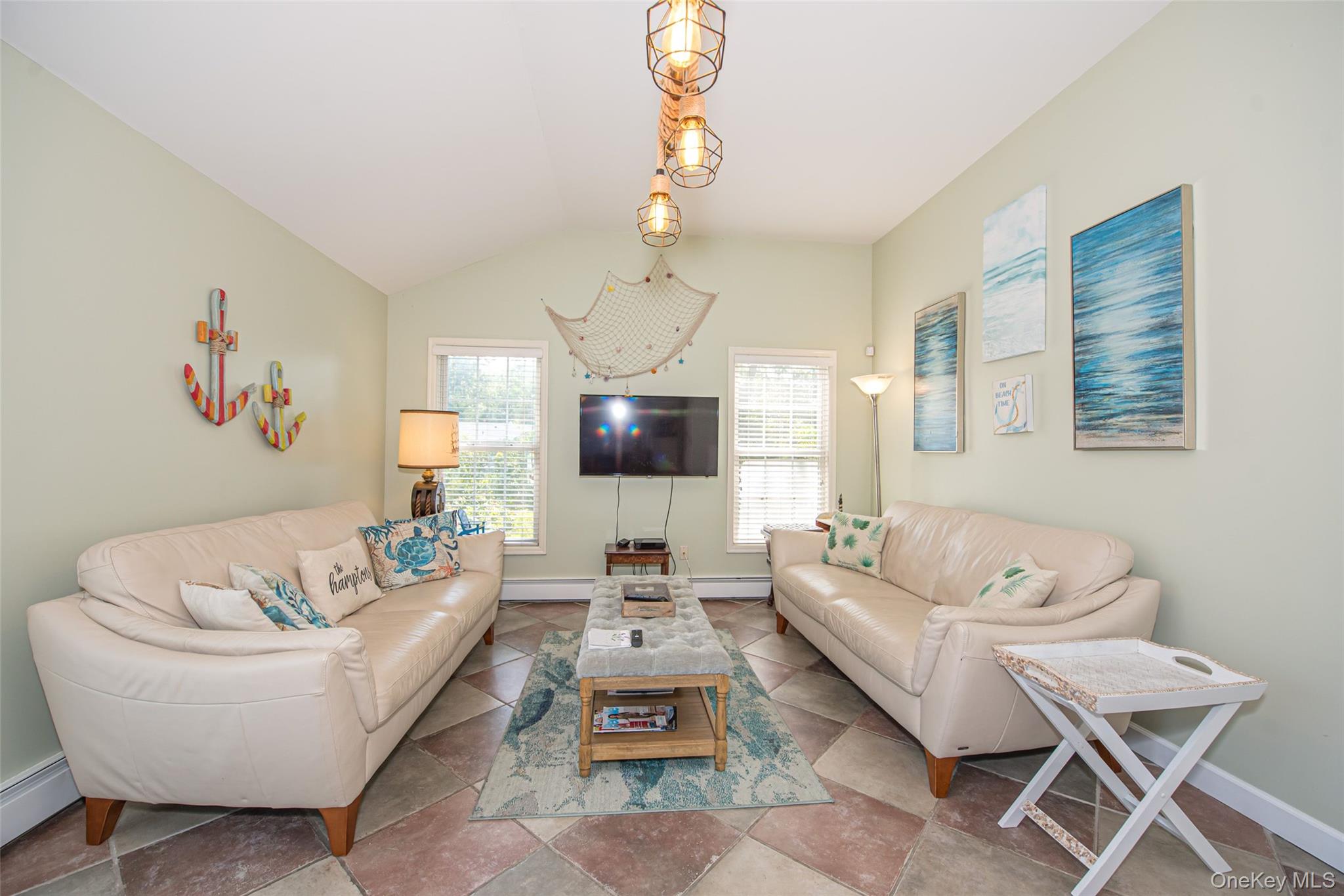 63 East Tiana Road Hampton Bays, NY 11946 - Photo 12 of 30 a living room with furniture a dining table and a chandelier