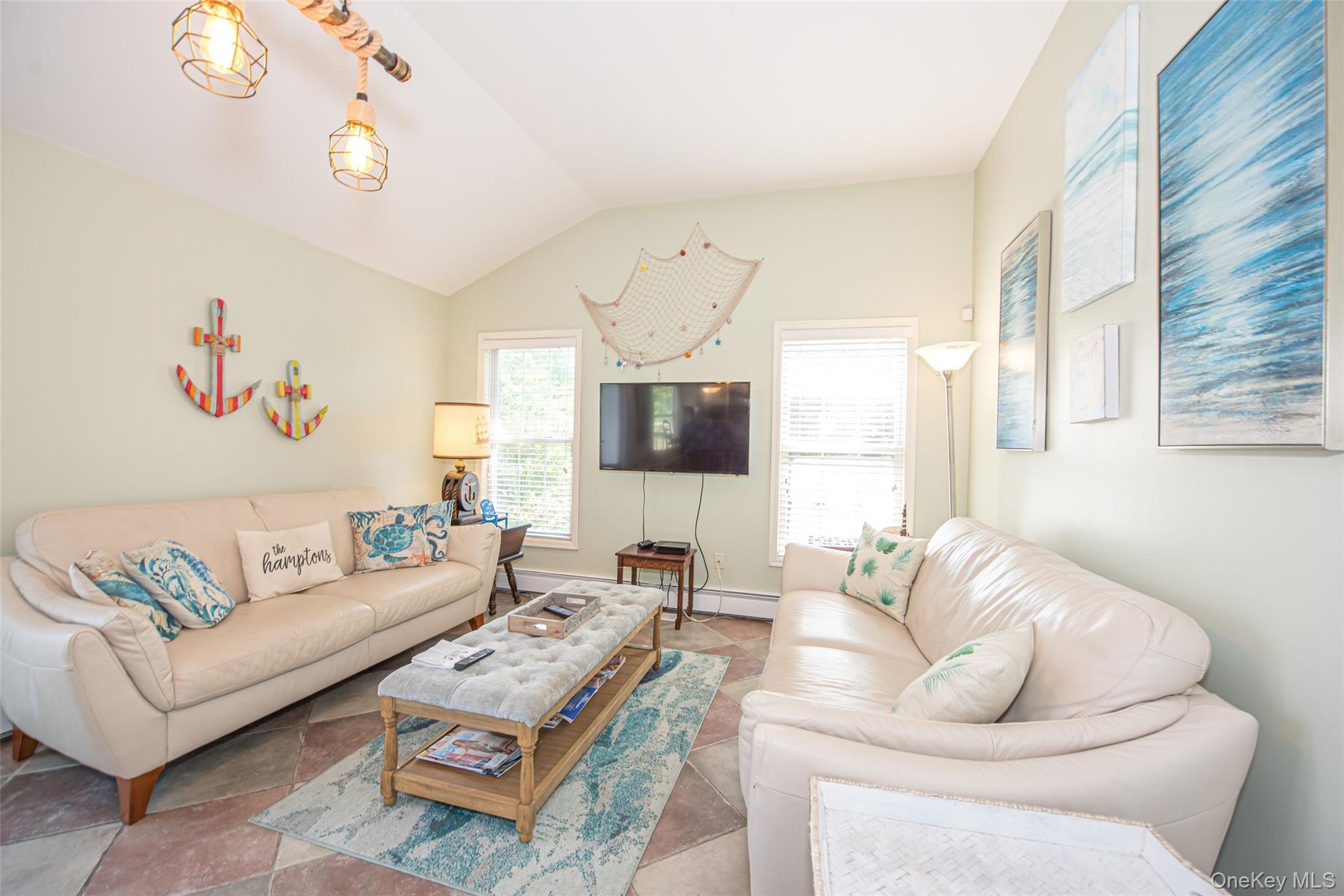 63 East Tiana Road Hampton Bays, NY 11946 - Photo 13 of 30 a living room with furniture a flat screen tv and a window