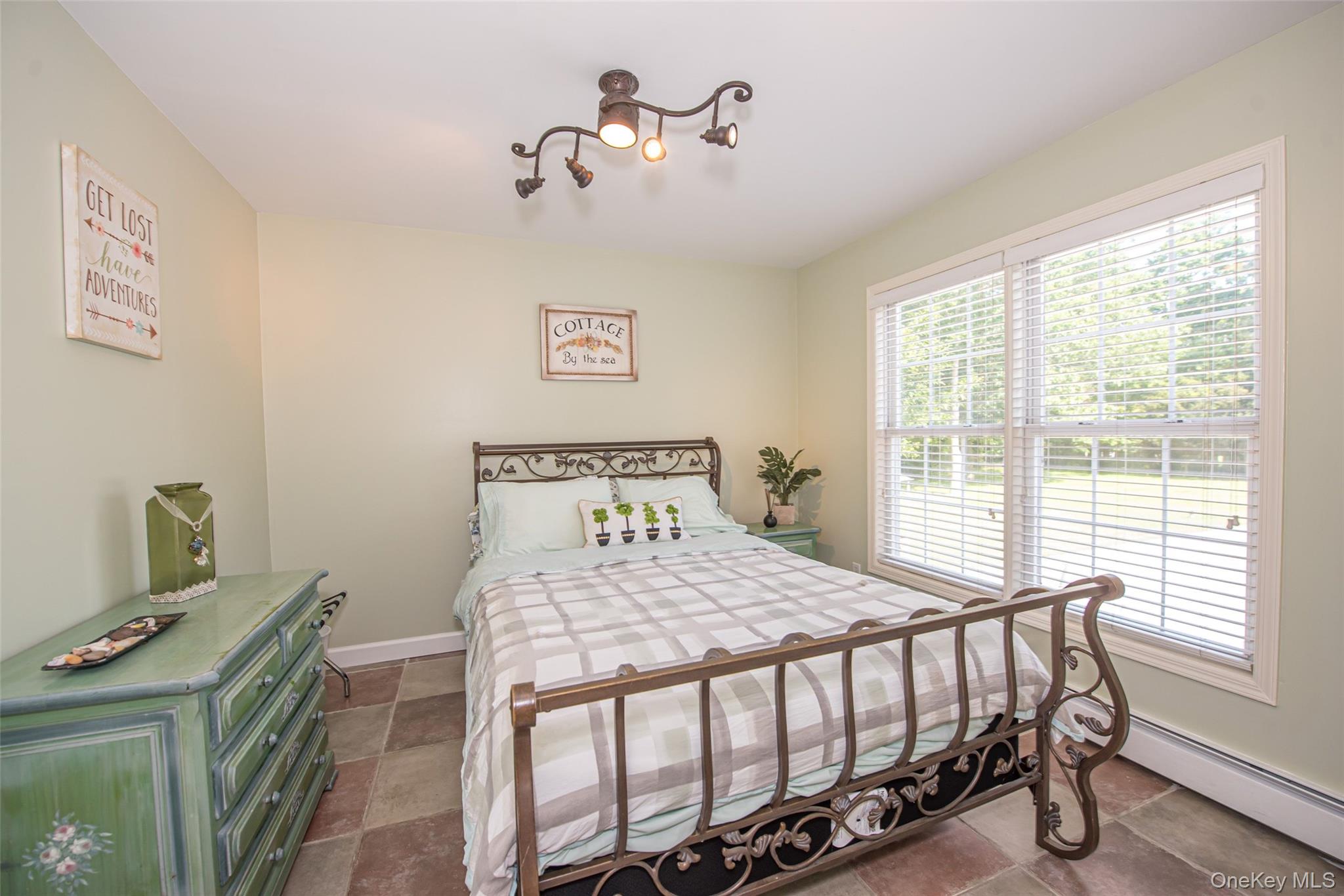 63 East Tiana Road Hampton Bays, NY 11946 - Photo 16 of 30 a bedroom with a bed and a table