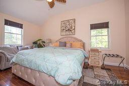 63 East Tiana Road Hampton Bays, NY 11946 - Photo 18 of 30 a bedroom with a bed and chair