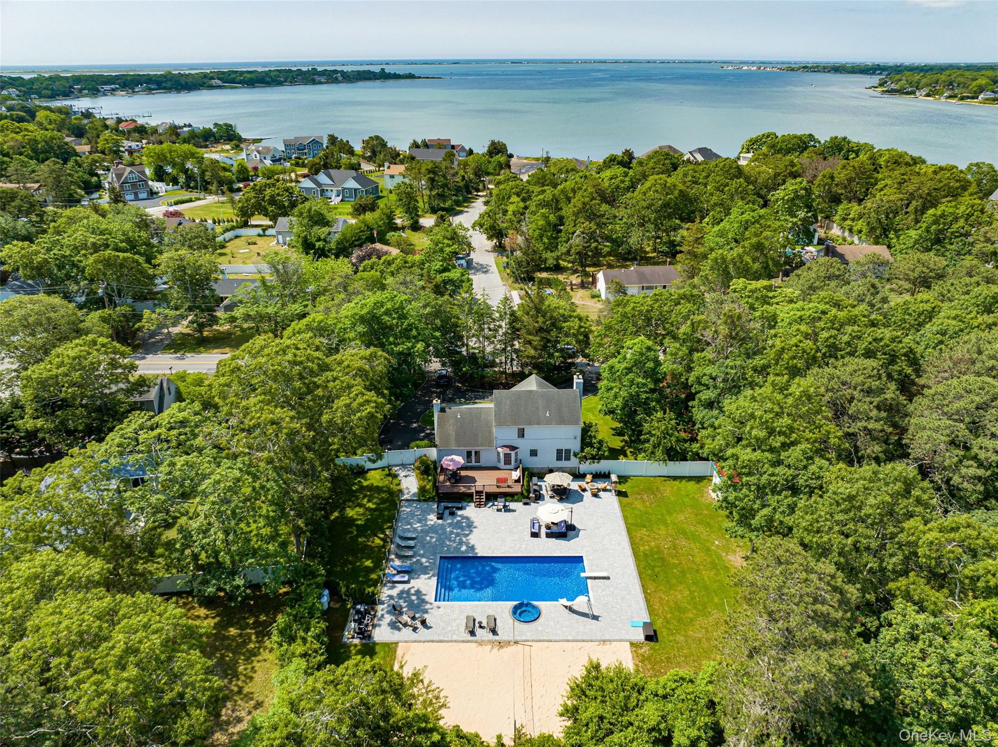 63 East Tiana Road Hampton Bays, NY 11946 - Photo 2 of 30 a view of a yard with an outdoor seating and lake view
