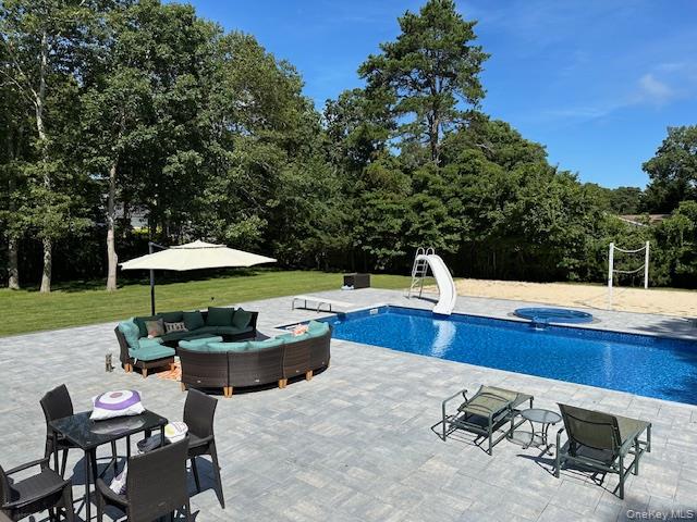 63 East Tiana Road Hampton Bays, NY 11946 - Photo 28 of 30 a view of backyard with outdoor seating and trees