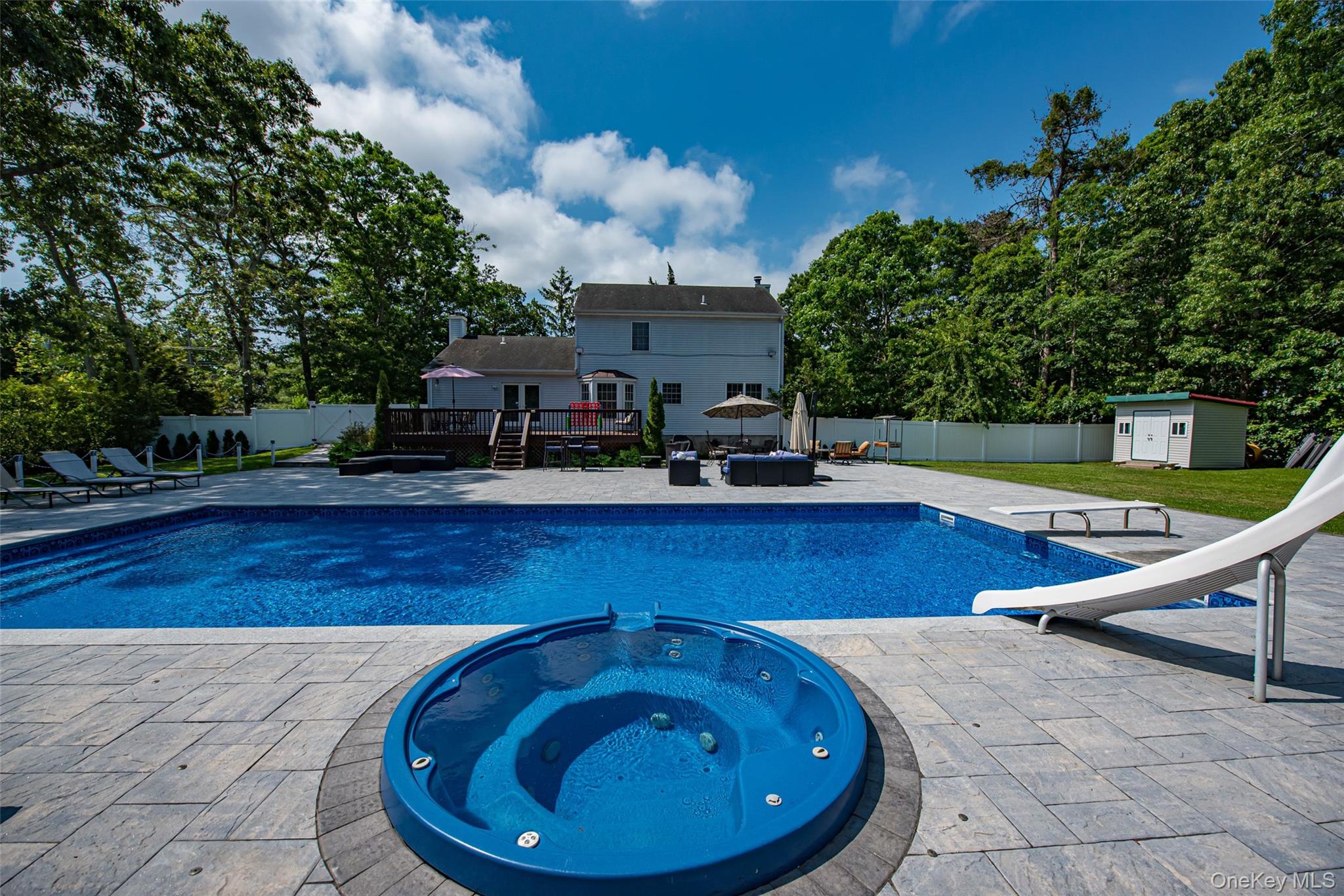 63 East Tiana Road Hampton Bays, NY 11946 - Photo 30 of 30 a swimming pool with outdoor seating
