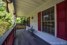 63 East Tiana Road Hampton Bays, NY 11946 - Photo 3 of 30 a view of balcony with two chairs and wooden floor