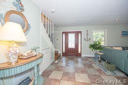 63 East Tiana Road Hampton Bays, NY 11946 - Photo 4 of 30 a view of an entryway with wooden floor