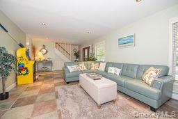 63 East Tiana Road Hampton Bays, NY 11946 - Photo 5 of 30 a living room with furniture and a couch