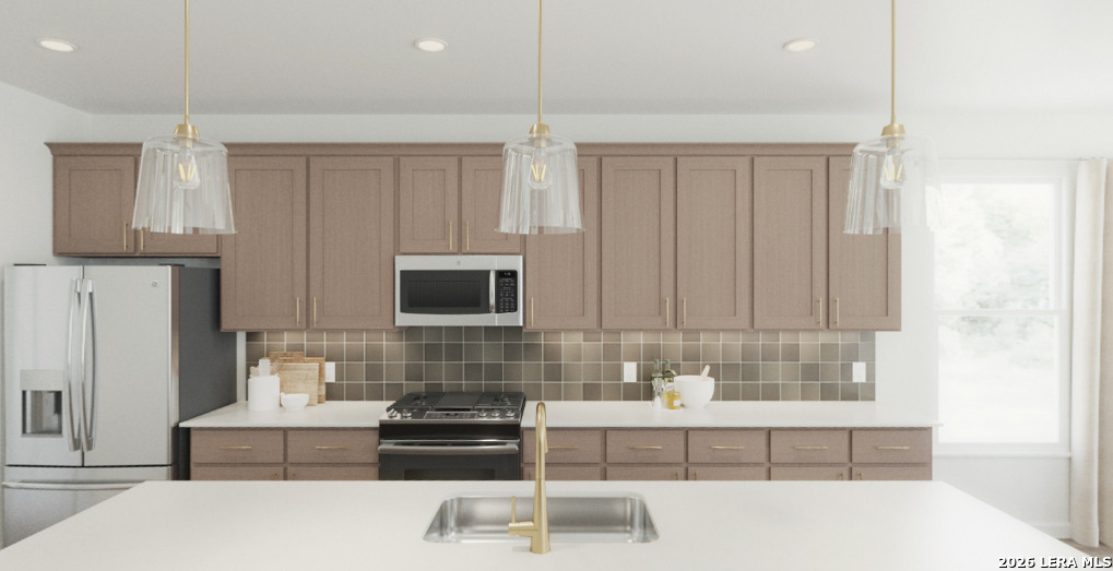 411 Nottabi Road Adkins, TX 78101 - Photo 4 of 8 a kitchen with kitchen island granite countertop a sink a stove and a refrigerator