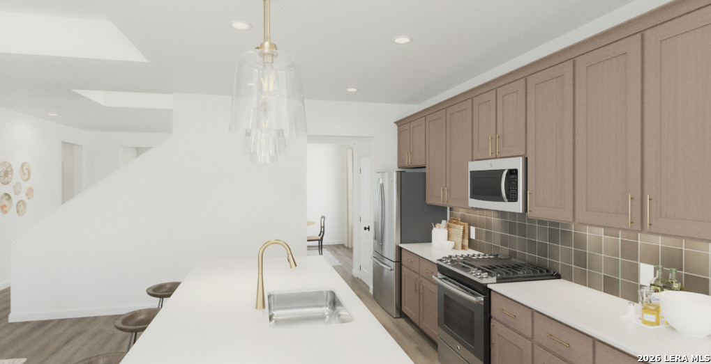 411 Nottabi Road Adkins, TX 78101 - Photo 6 of 8 a kitchen with a sink stove and refrigerator