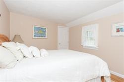 608 Old Post Road Cotuit, MA 02635 - Photo 18 of 30 a bedroom with a bed and a window