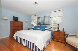 608 Old Post Road Cotuit, MA 02635 - Photo 22 of 30 a bedroom with a bed and a night stand