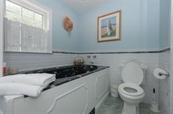 608 Old Post Road Cotuit, MA 02635 - Photo 25 of 30 a bathroom with a toilet a sink and a window